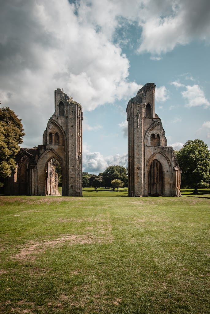 Explore the majestic ruins of Glastonbury Abbey, a historic site in Somerset, England, under a bright sky.