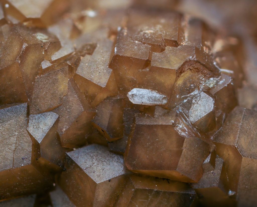 Detailed macro shot of brown calcite crystals with visible texture and translucent properties.